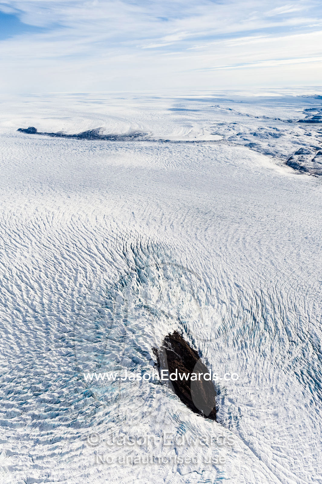 Pressure ridges in a glacier build up around an island in the Greenland Ice Sheet. Greenland Ice Sheet, Qeqqata Municipality, Kangerlussuaq, Greenland.