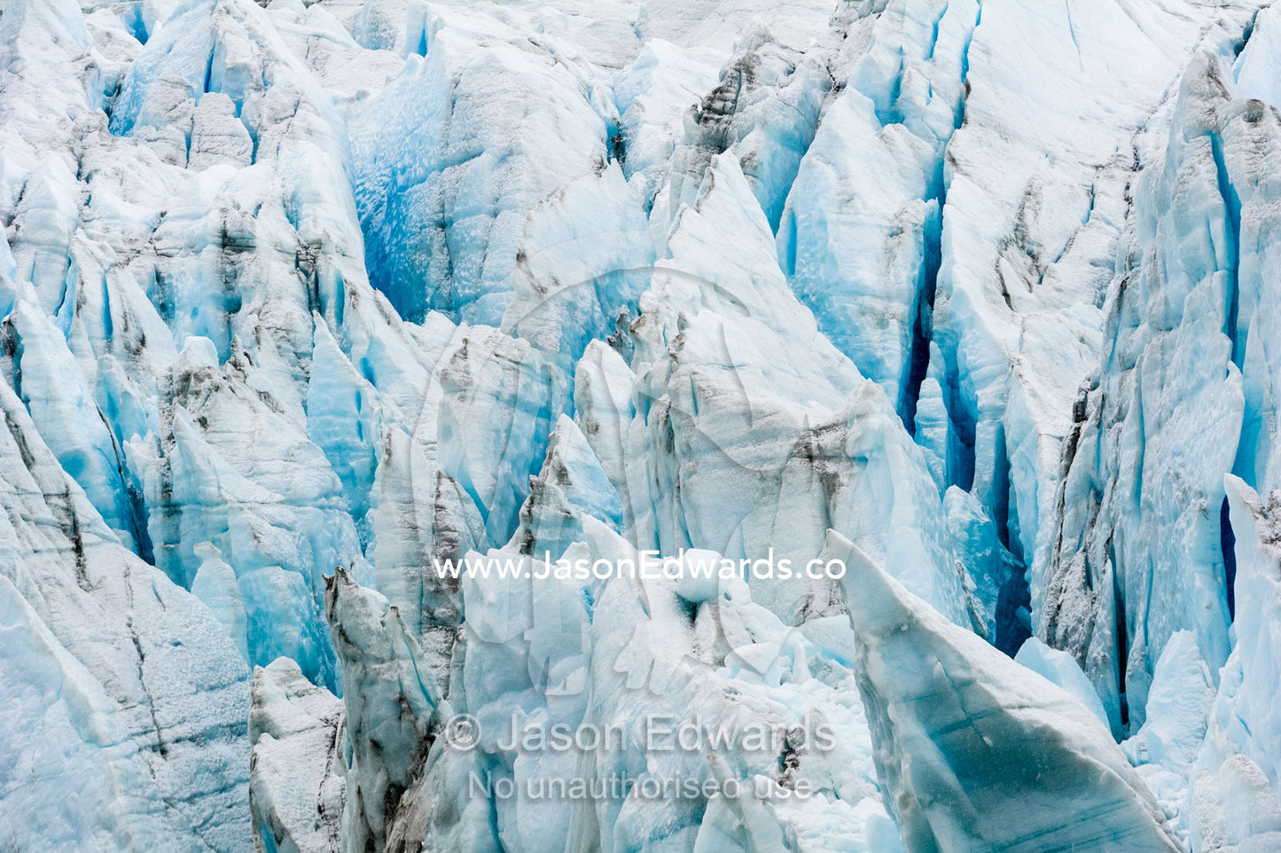 Treacherous jagged ice spires on a glacier fracture zone known as serac. Greenland Ice Sheet, Qeqqata Municipality, Kangerlussuaq, Greenland.