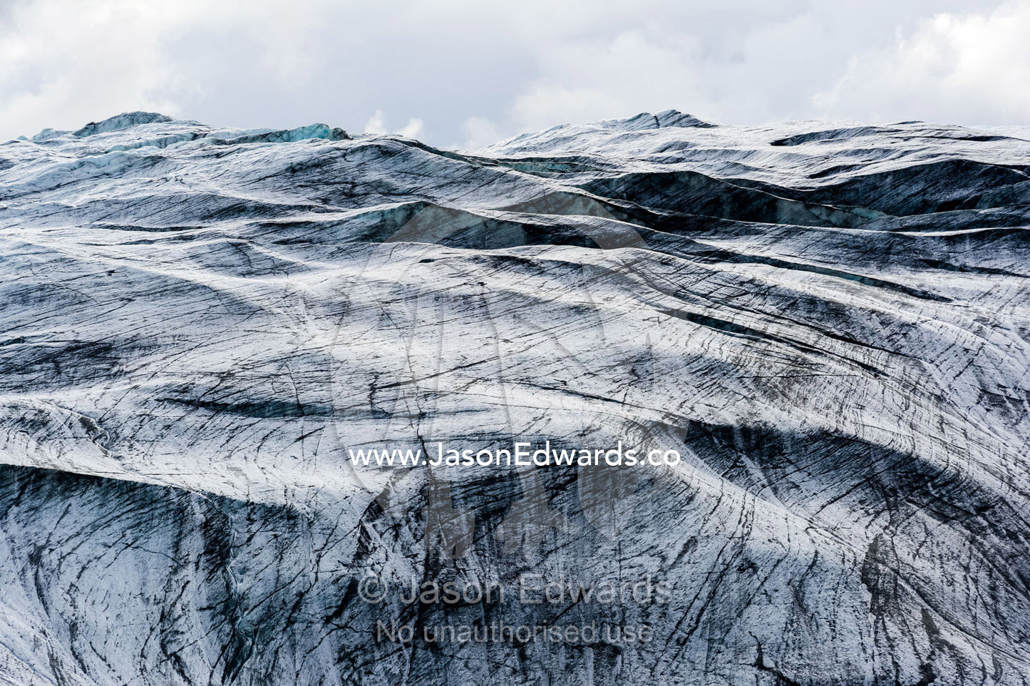 Lines scar the ice on the inhospitable surface of a glacier. Isunnguata Sermia Glacier, Kangerlussuaq, Qeqqata Municipality, Greenland.