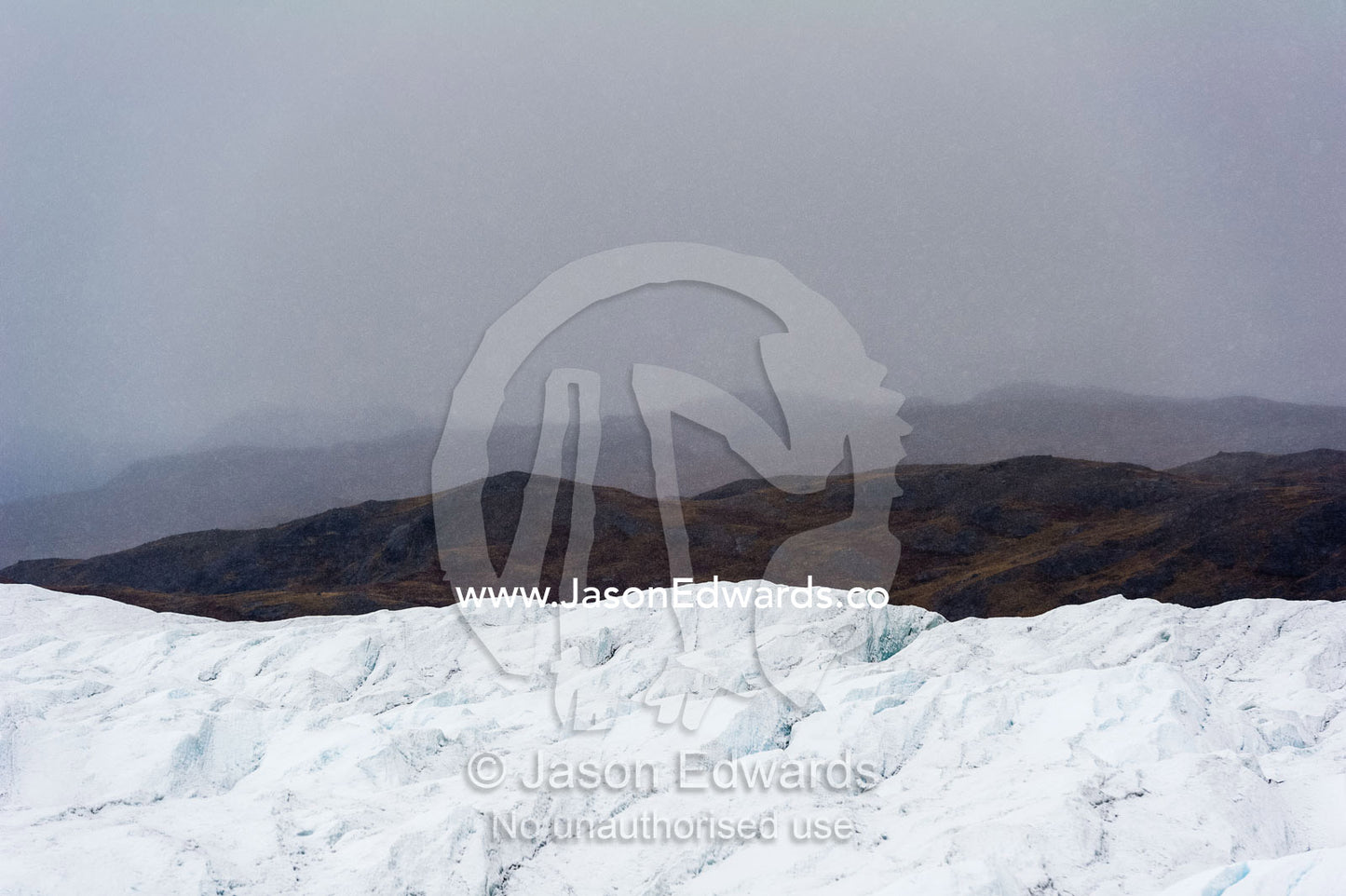 A barren, icy wasteland where the Greenland Ice Sheet presses against a rocky shore. Isunngua Highland, Greenland Ice Sheet, Kangerlussuaq, Qeqqata Municipality, Greenland.