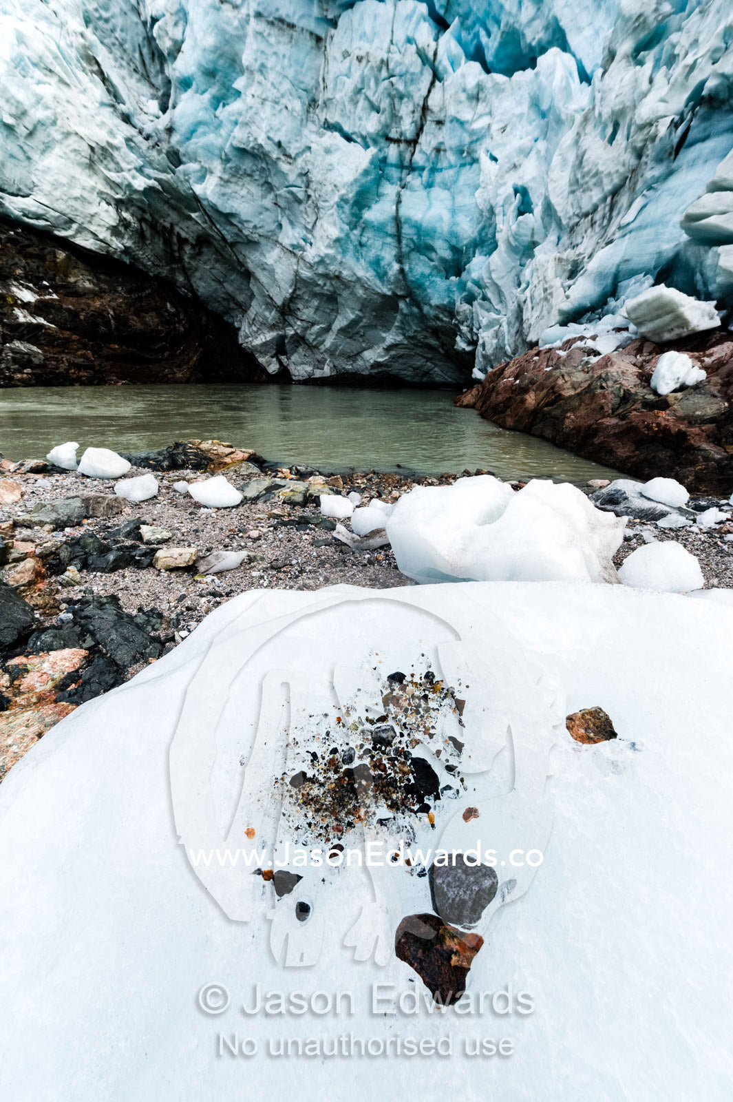 Pebbles trapped in a glacier exposed after the ice melts. Russell Glacier, Greenland Ice Sheet, Qeqqata Municipality, Kangerlussuaq, Greenland.