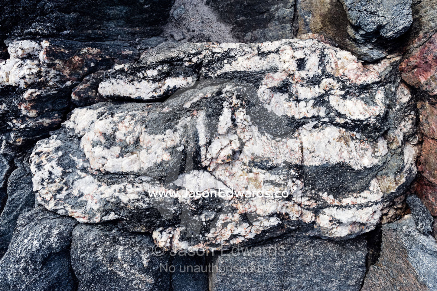 Layers of quartz imbedded in a rock exposed by a receding glacier. Russell Glacier, Greenland Ice Sheet, Qeqqata Municipality, Kangerlussuaq, Greenland.