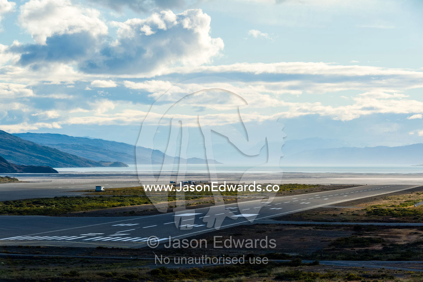 An airport tarmac facing a fjord in the arctic. Kangerlussuaq Airport, Kangerlussuaq, Qeqqata Municipality, Greenland.
