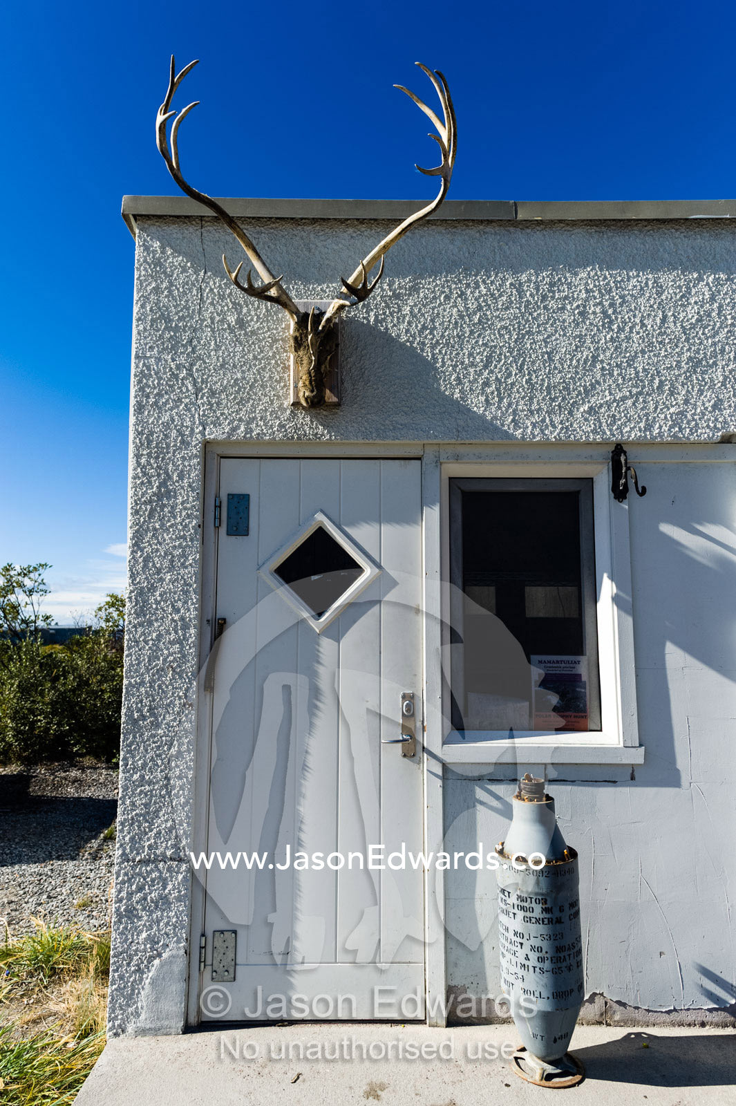 A Caribou skull mounted above a doorway in a village. Kangerlussuaq, Qeqqata Municipality, Greenland.