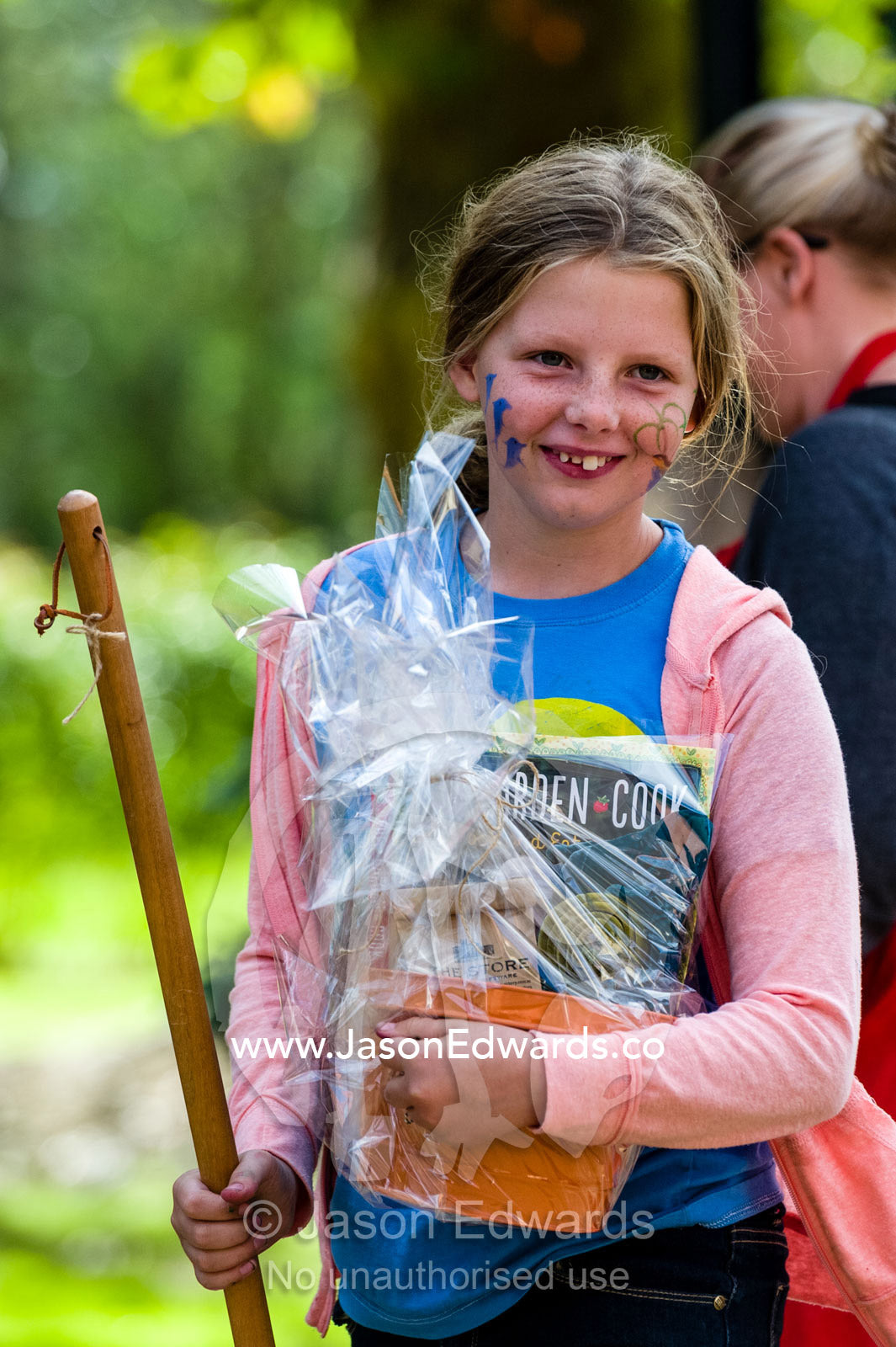 A happy girl displays her prizes after winning an Easter coloring competition. Euroa Butter and Ice Factory, Euroa, Strathbogie, Victoria, Australia.