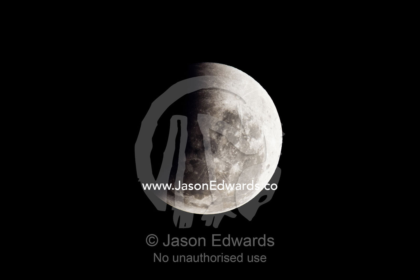 A shadow passes across the face of a full moon during an eclipse. Carlton North, Melbourne, Victoria, Australia.