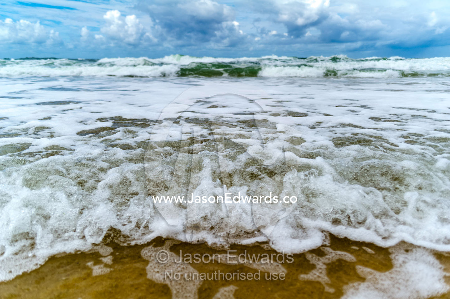 Storm surge waves rolling onto an empty beach. Point Arkwright, Yaroomba Beach, Queensland, Australia.