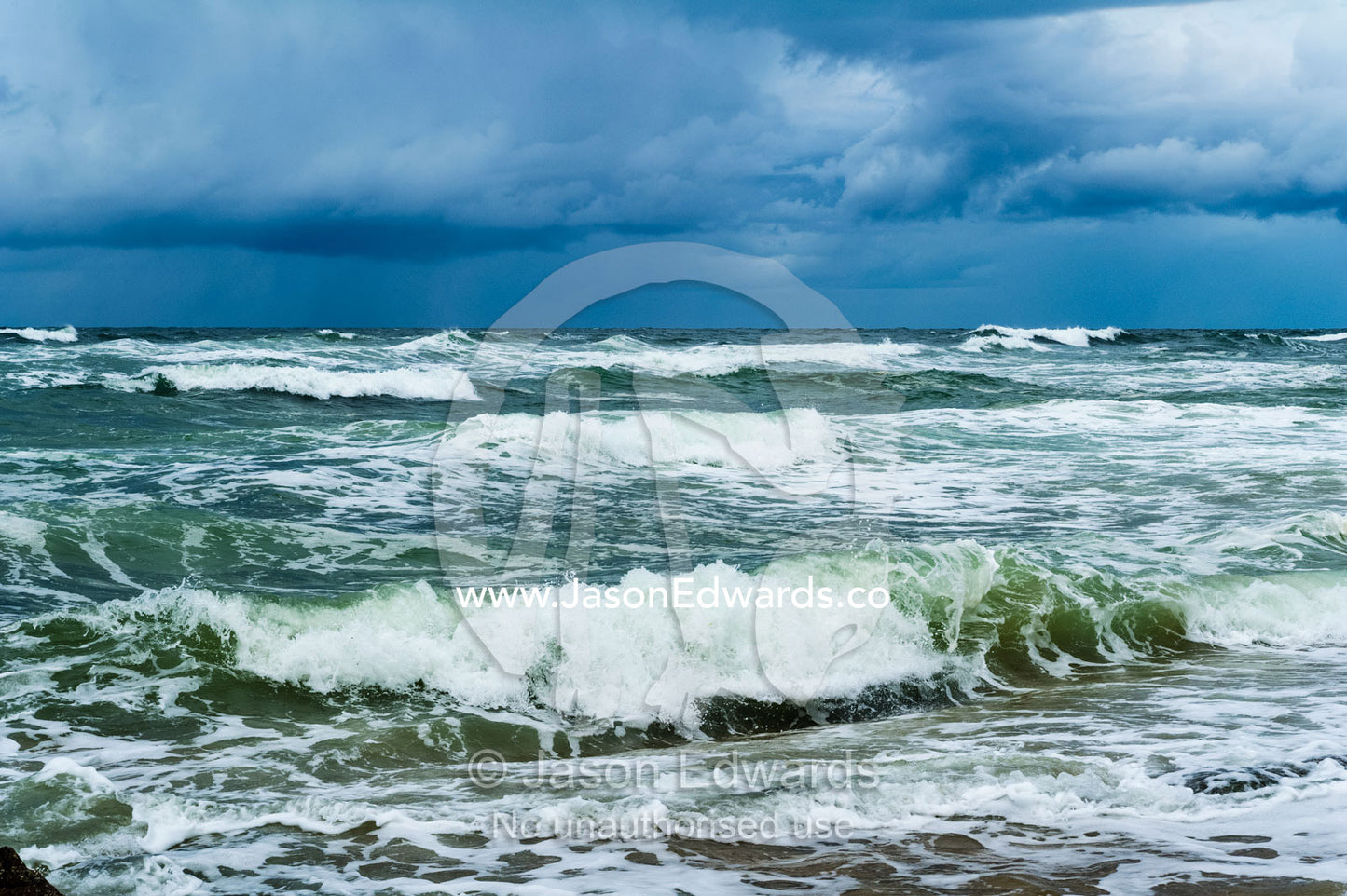 Storm surge waves rolling onto an empty beach. Point Arkwright, Yaroomba Beach, Queensland, Australia.