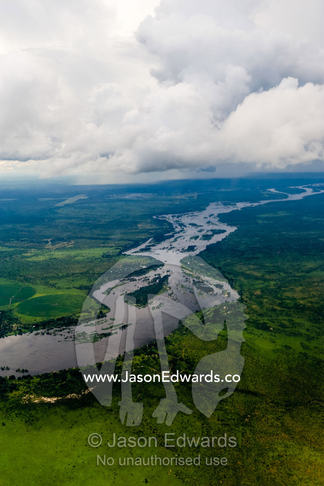 The mighty Zambezi River flowing through a lush savannah plain. Zambezi River, Mosi-oa-Tunya National Park, Zambia. Zambia-Zimbabwe Border.
