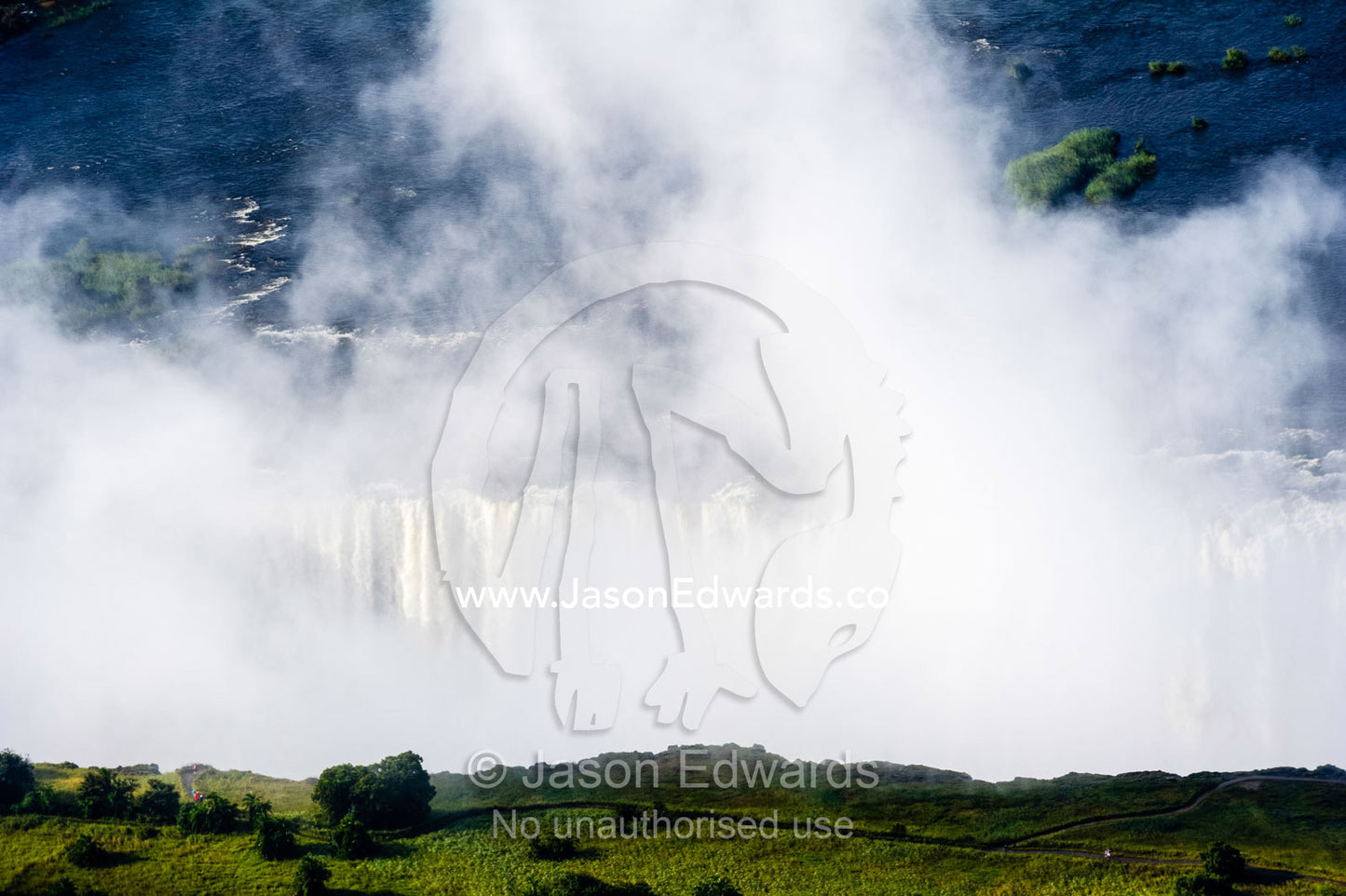 Mist shrouds the Zambezi River where it cascades into First Gorge at Victoria Falls. Zambezi River, Victoria Falls, Mosi-oa-Tunya National Park, Victoria Falls National Park, Zambia.