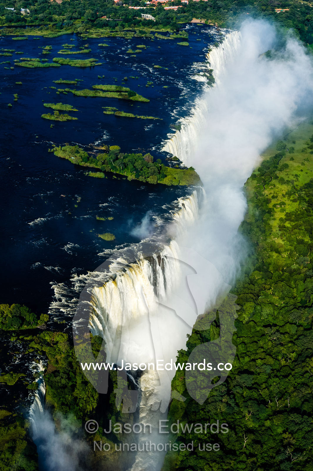 Torrents of water from the Zambezi River cascade over Victoria Falls into the chasm at First Gorge. Zambezi River, Victoria Falls, Mosi-oa-Tunya National Park, Victoria Falls National Park, Zambia.