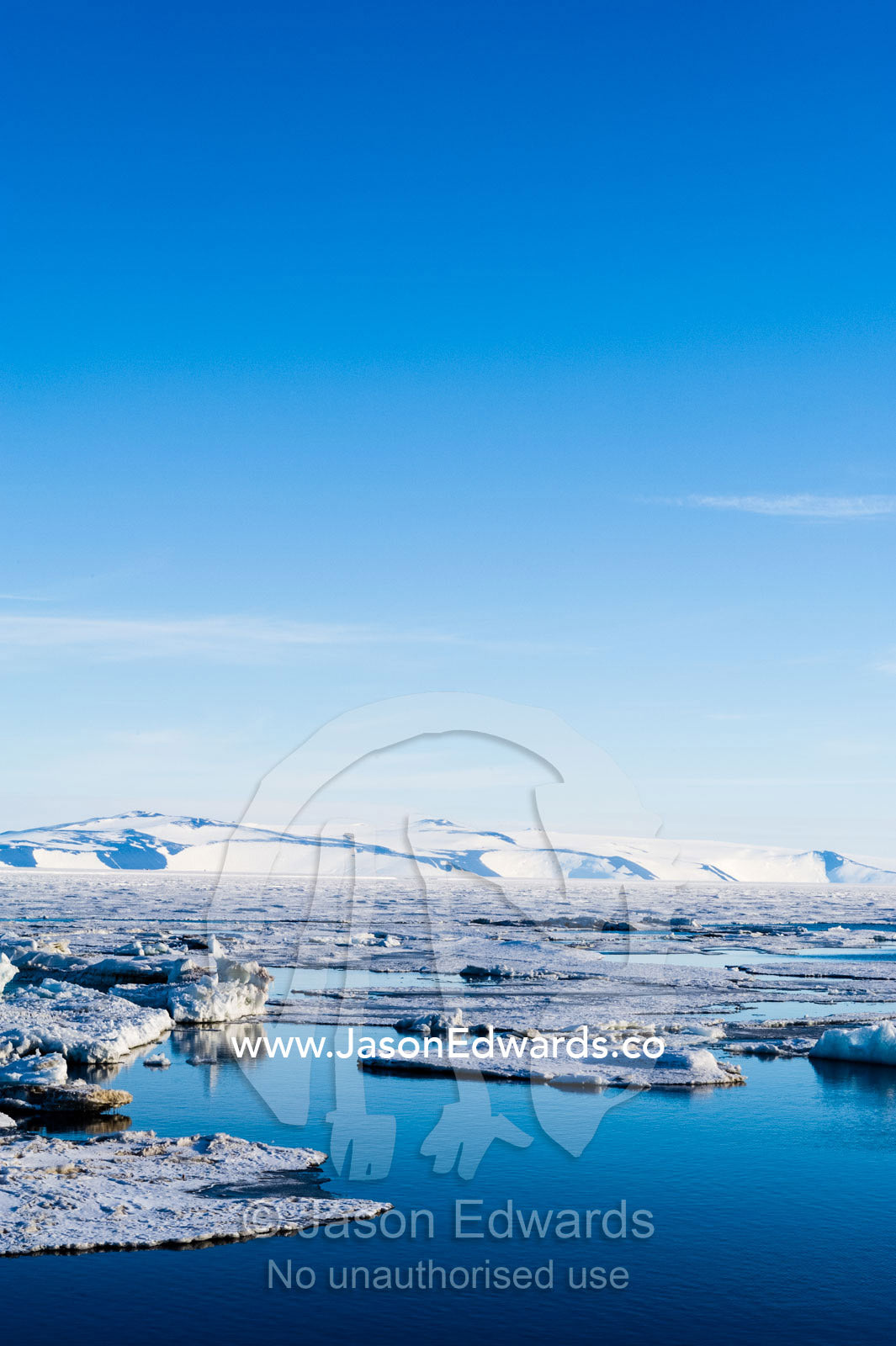 Ocean melt ponds expand where the Antarctic sea ice is melting in summer. Haskell Strait, McMurdo Sound, Ross Island, Antarctica