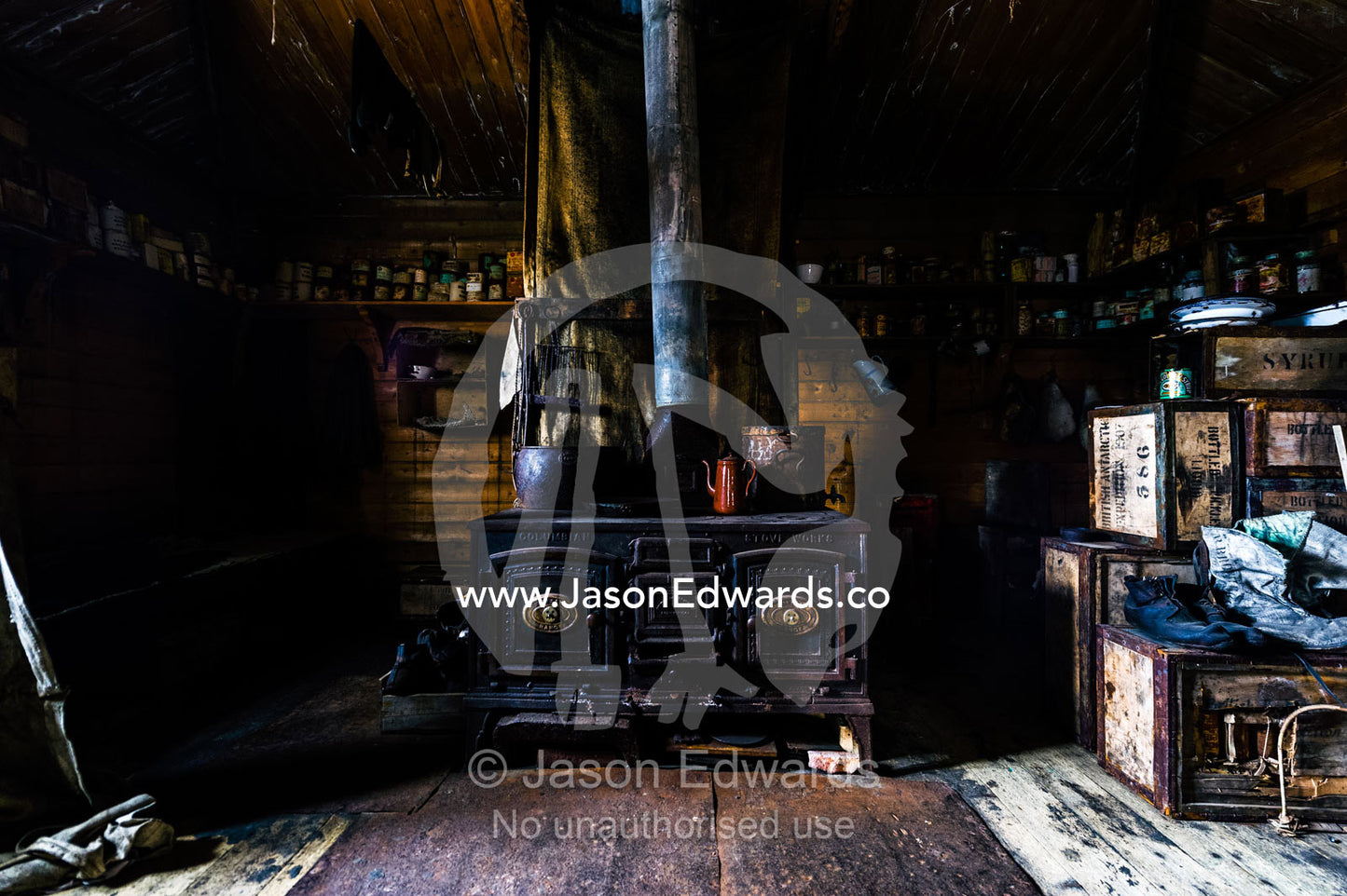 The inside of Antarctic explorer Ernest Shackleton's hut with its large stove, food supplies and bed bunks. Shackleton's Hut, Cape Royds, Ross Island, Antarctica.