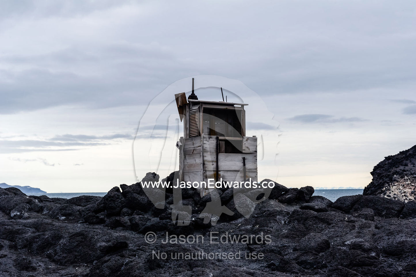 A weather station on an exposed rocky outcrop near Antarctic explorer Ernest Shackletons Hut. Shackleton's Hut, Cape Royds, Ross Island, Antarctica.
