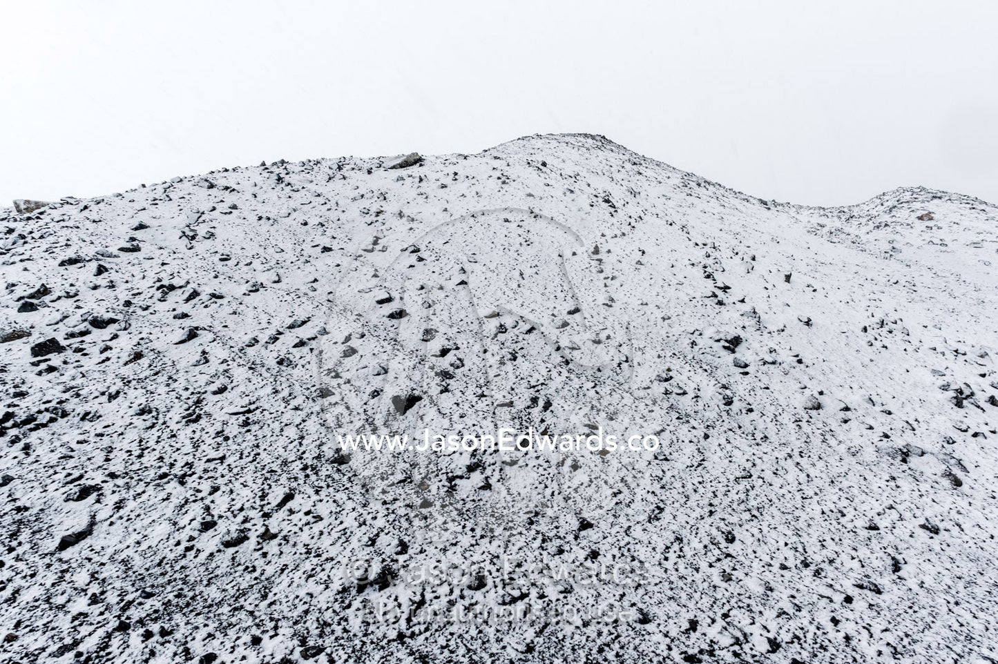 A barren volcanic slope covered in snow during a storm. Cape Bird Ice Cap, Adelie Glacier, Cape Bird, Ross Island, Antarctica