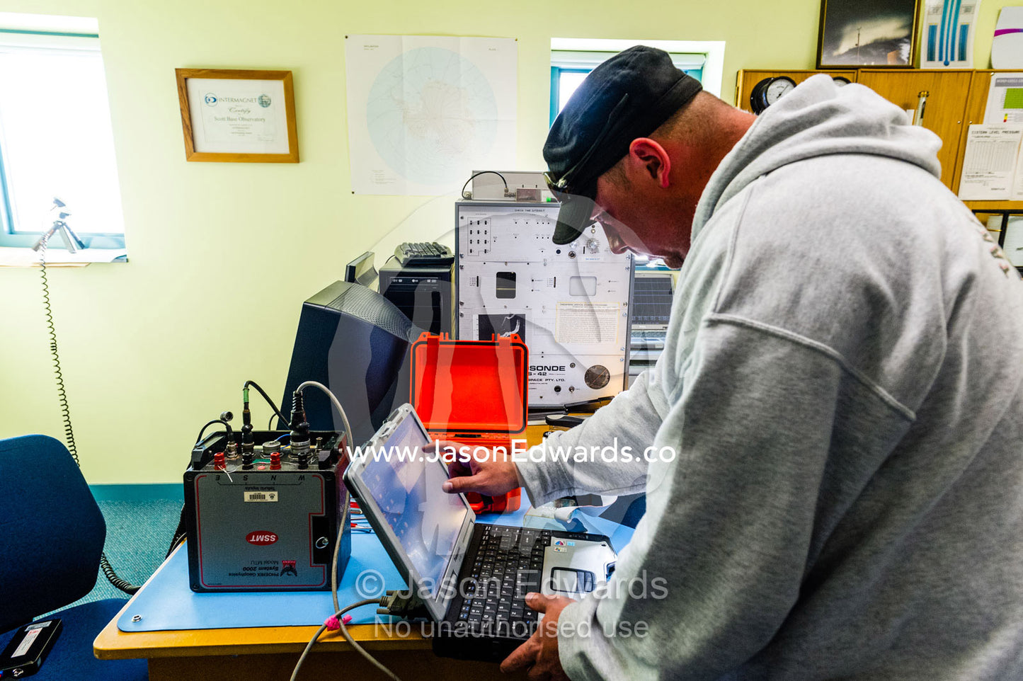 Science researchers studying volcanology and Mount Erebus repair a malfunctioning field sensor. Hatherton Laboratory, Scott Base, Pram Point, Hut Point Peninsula, Ross Island, Antarctica.