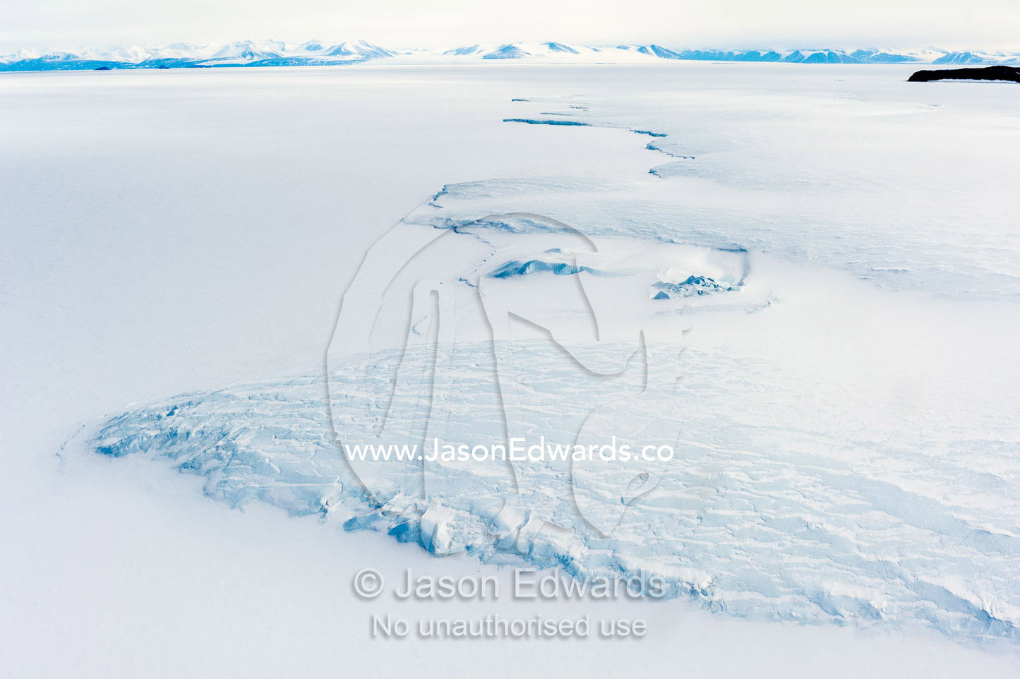 The Erebus Glacier Tongue flows onto the sea ice of the Ross Sea. Erebus Glacier Tongue, Erebus Bay, Tent Island, Ross Island, Antarctica.