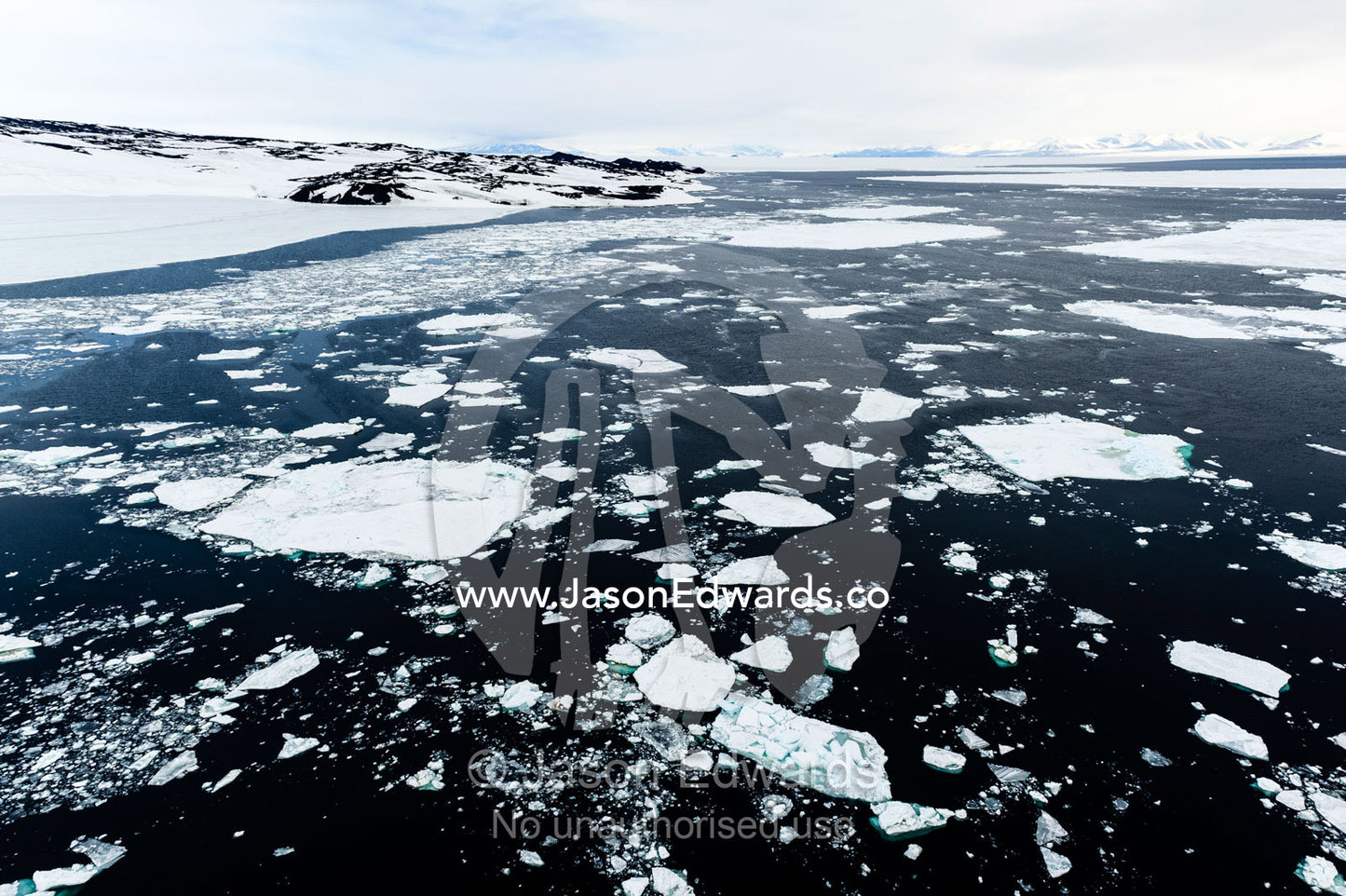 Icebergs and slush from sea ice break-up on the open ocean during the Antarctic summer. Cape Royds, Ross Island, Antarctica.