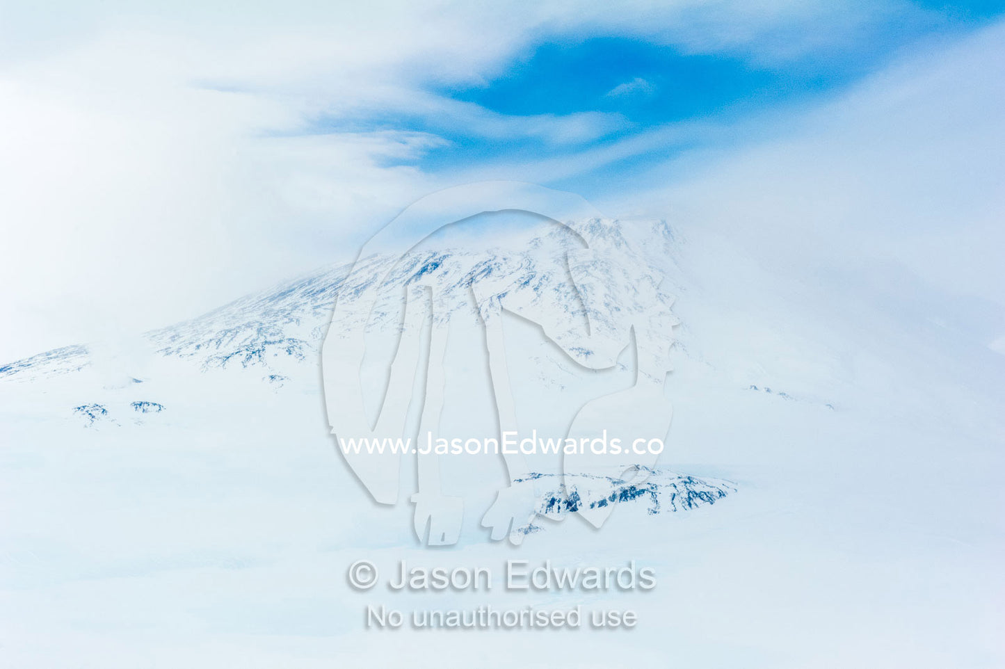 Ice sheets and snow cover the slopes of Mount Erebus an active volcano. Mount Erebus, Ross Island, Antarctica.
