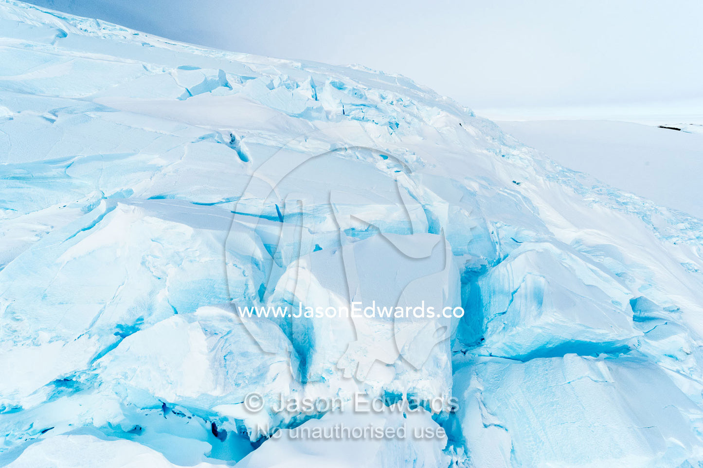 Treacherous crevasse scour the surface of a glacier leading onto the sea ice in Antarctica. Esser Bluff, Mount Erebus, Ross Island, Antarctica.