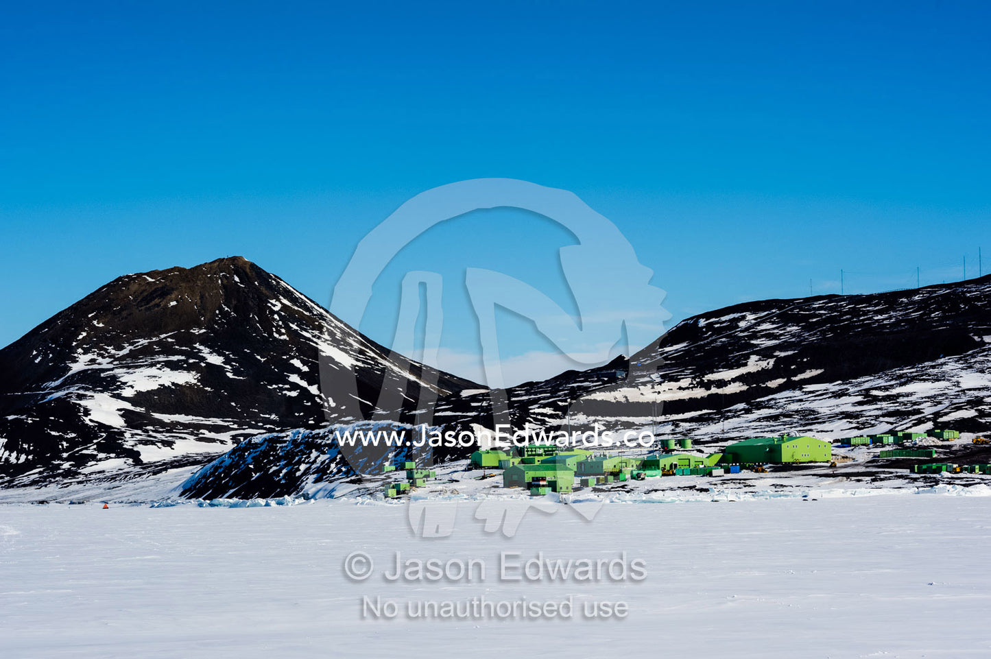 Scott Base sits on a rocky spit of land overlooking the sea ice. Scott Base, Pram Point, Hut Point Peninsula, Ross Island, Antarctica.