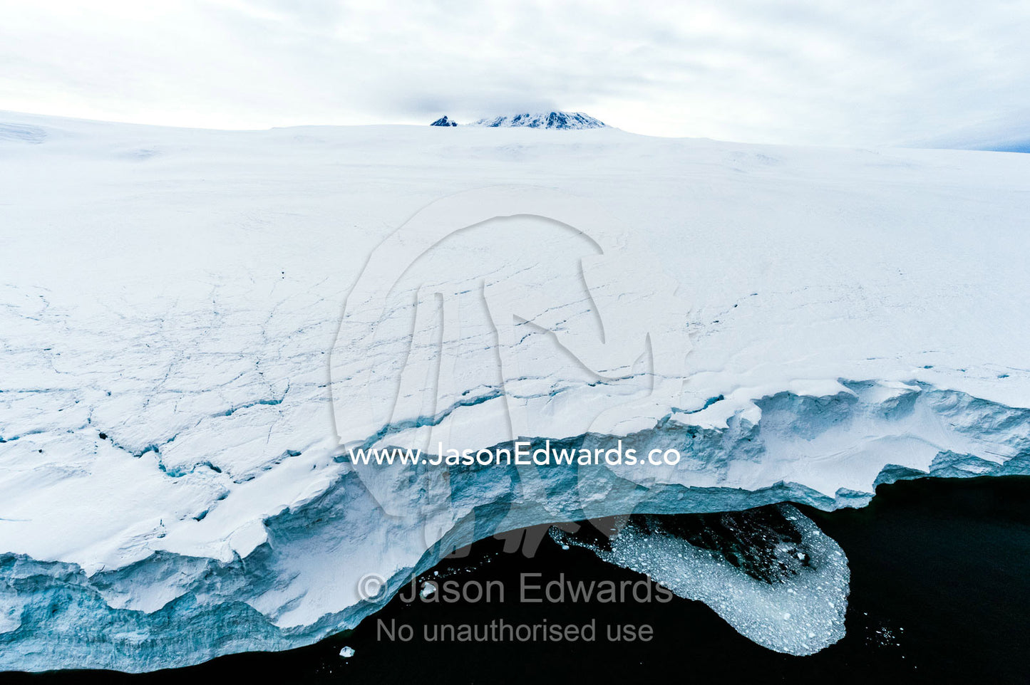 Towering ocean ice cliffs and crevasse fields of a glacier flowing off the slopes of Mount Erebus an active volcano. Wohlschlag Bay, Endeavour Piedmont, Mount Erebus, Ross Island, Antarctica.