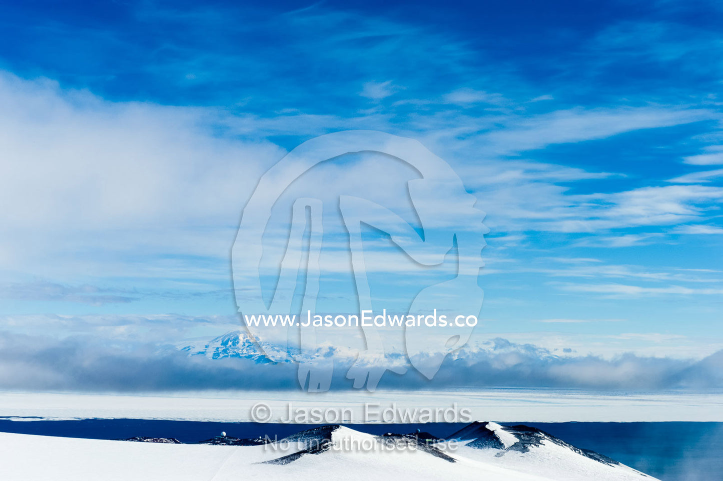 A snow and ice covered mountain plateau overlooking the Ross Sea. Royal Society Range, McMurdo Sound, Ross Island, Antarctica.