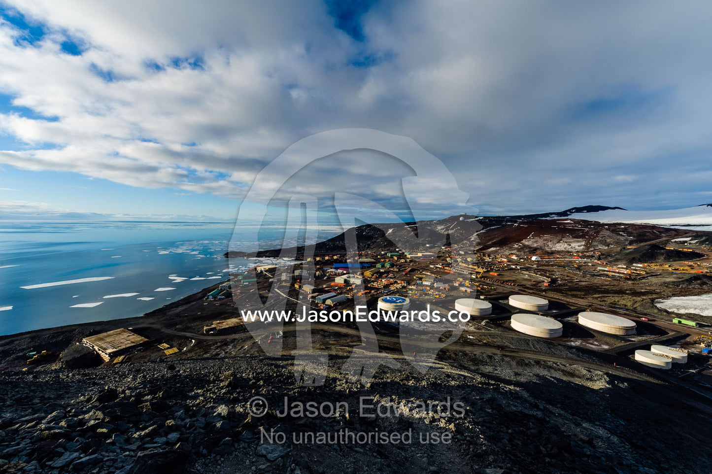 The enormous oil tanks and sprawling facilities of McMurdo Station the largest base in Antarctica. McMurdo Station, Ross Island, Antarctica.