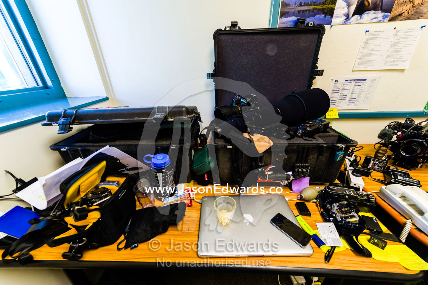 A photographers office desk covered in equipment and computers in Antarctica. Scott Base, Pram Point, Hut Point Peninsula, Ross Island, Antarctica.