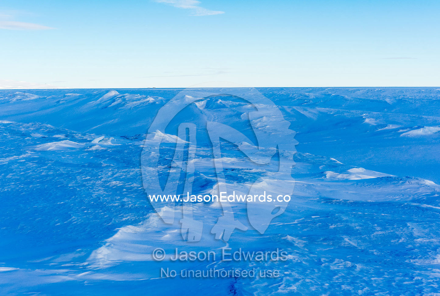 Snow drifts and fractured ice on the sea ice. Pram Point, McMurdo Sound, Ross Island, Antarctica.