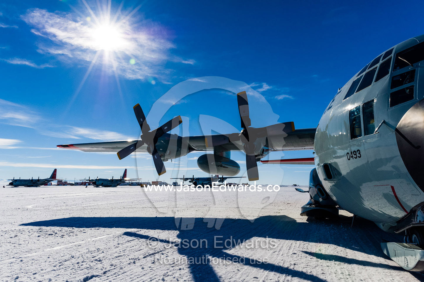 US Air force Hercules resting on skis on a sea ice tarmac. Royal Society Range, Pegasus Field, McMurdo Ice Shelf, Ross Island, McMurdo Sound, Antarctica.