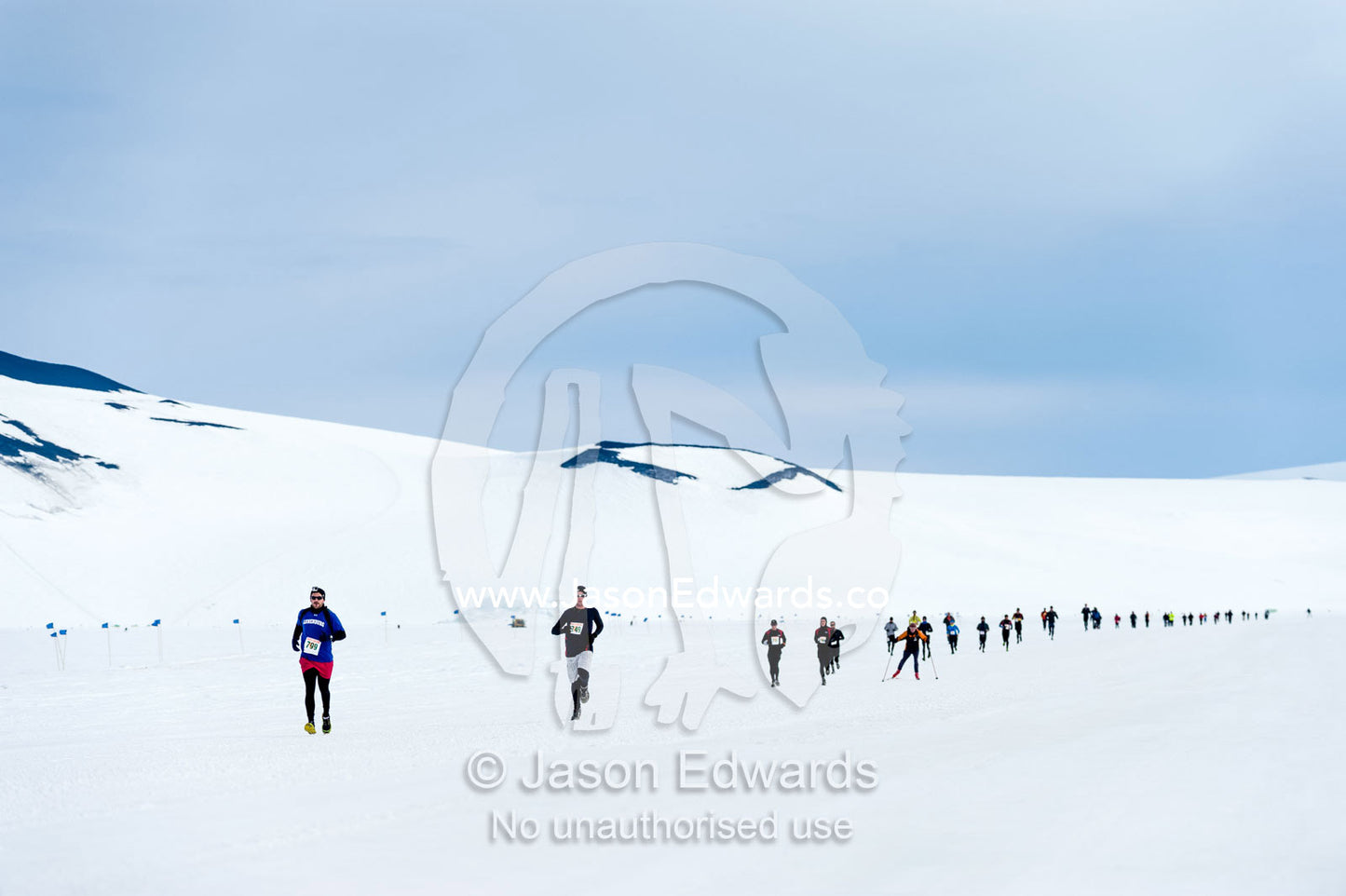 Runners from the Antarctic bases cross the sea ice during the Antarctic marathon. Ross Ice Shelf, Ross Island, Antarctica.