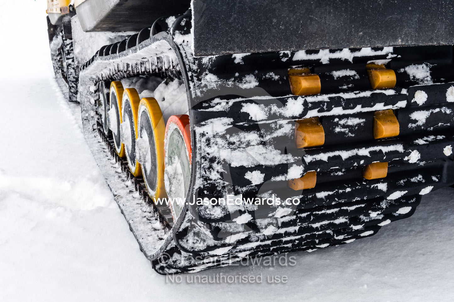 A Hagglund ice vehicle travels between crevasse on a mountain during the Antarctic summer. Turtle Rock, Erebus Bay, McMurdo Sound, Ross Island, Antarctica.