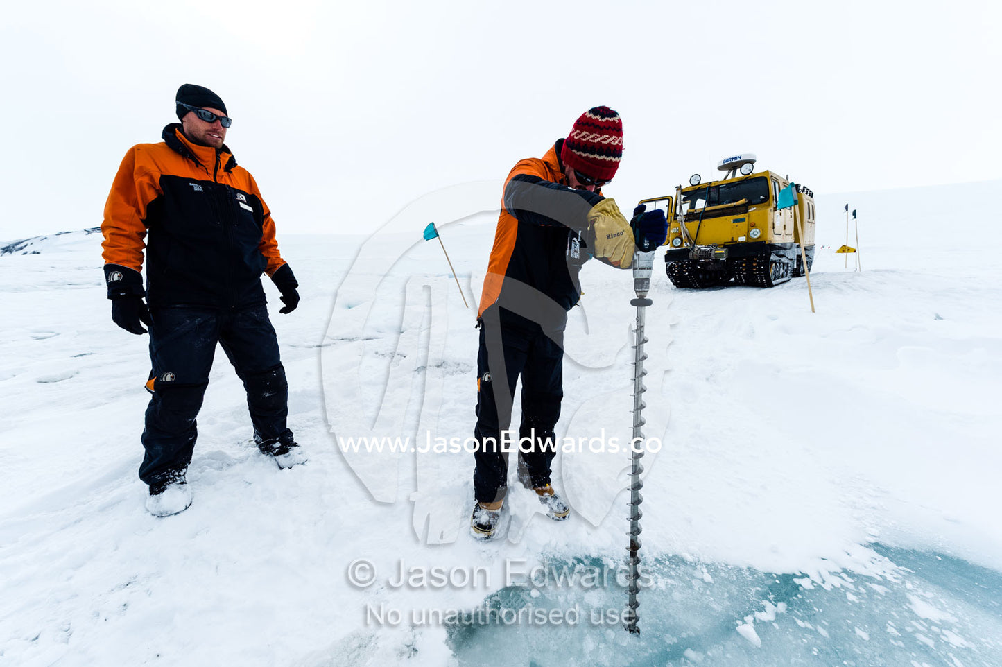 Testing the depth of sea ice for a Hagglund ice vehicle safety during the Antarctic summer. Turtle Rock, Erebus Bay, McMurdo Sound, Ross Island, Antarctica.