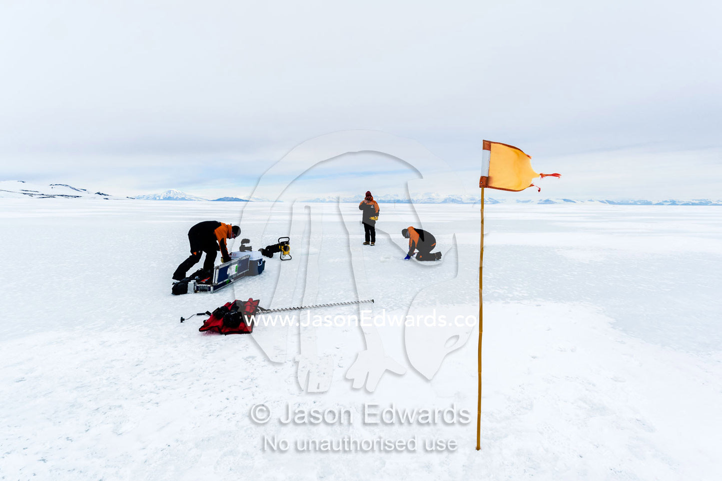Researchers drill core samples from the sea ice to collect extremophiles from beneath the ice to study. Turtle Rock, Erebus Bay, McMurdo Sound, Ross Island, Antarctica.