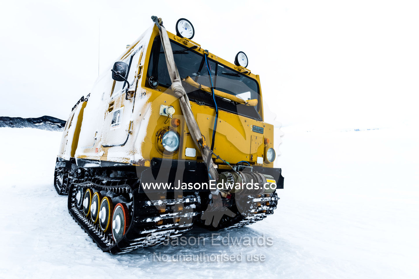 A Hagglund ice vehicle travels across the frozen sea ice during the Antarctic summer. Castle Rock Road, Hut Point Peninsula, Ross Island, Antarctica.