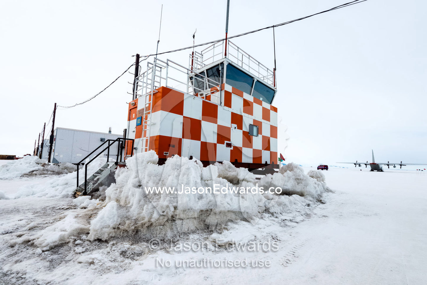 A checkered airport control tower on the Ross Ice Shelf. Royal Society Range, Pegasus Field, McMurdo Ice Shelf, Ross Island, McMurdo Sound, Antarctica.