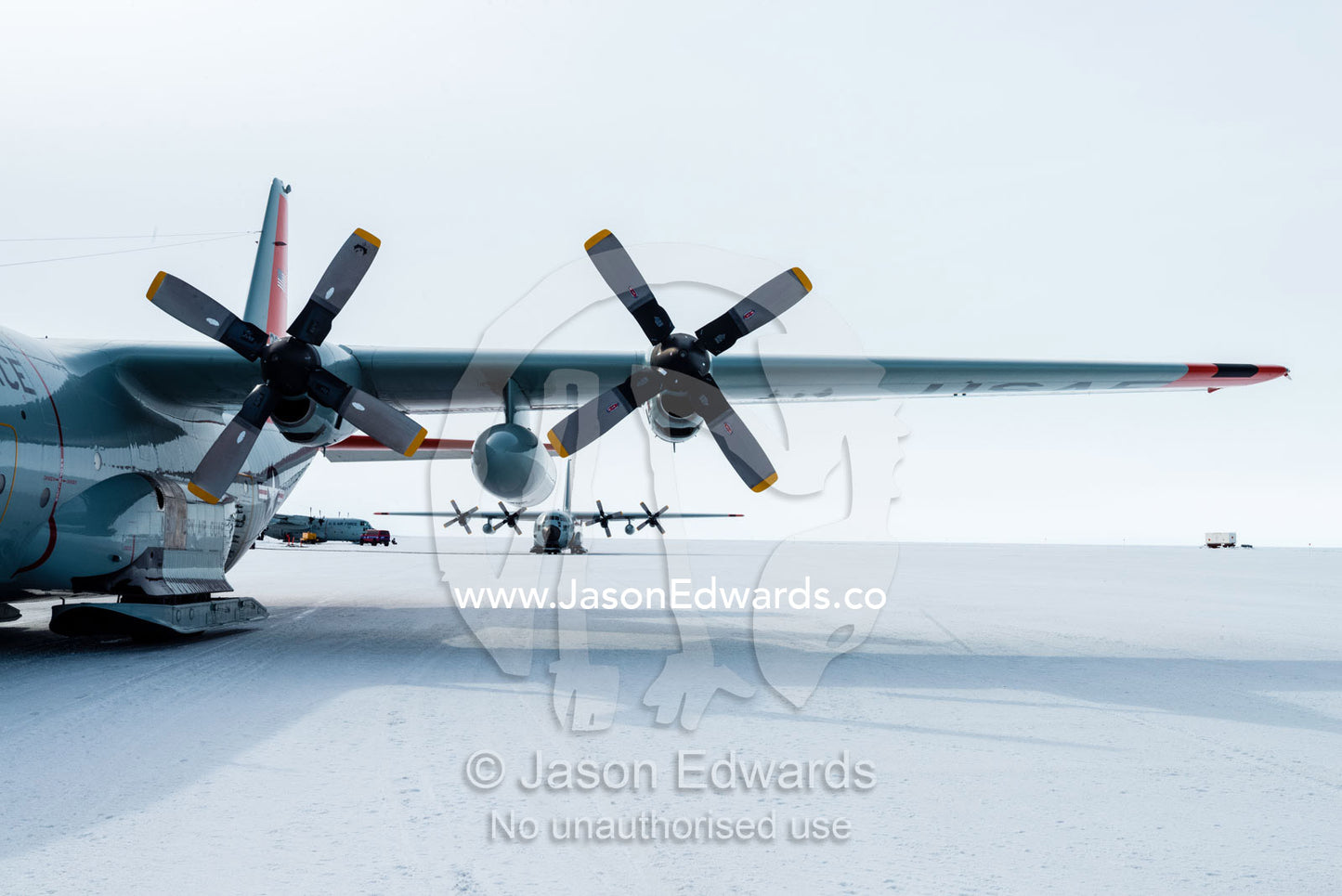 US Air force Hercules resting on skis on a sea ice tarmac. Royal Society Range, Pegasus Field, McMurdo Ice Shelf, Ross Island, McMurdo Sound, Antarctica.