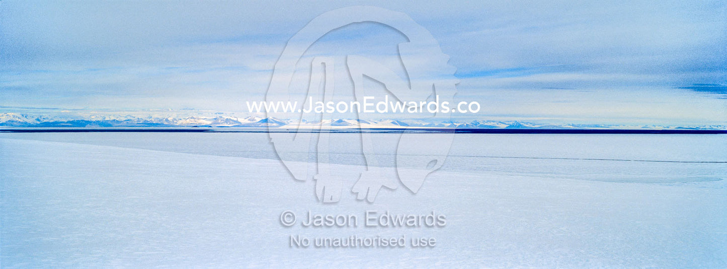 Snow drifts gather on the sea ice in Antarctica. Royal Society Range, McMurdo Sound, Ross Island, Antarctica.