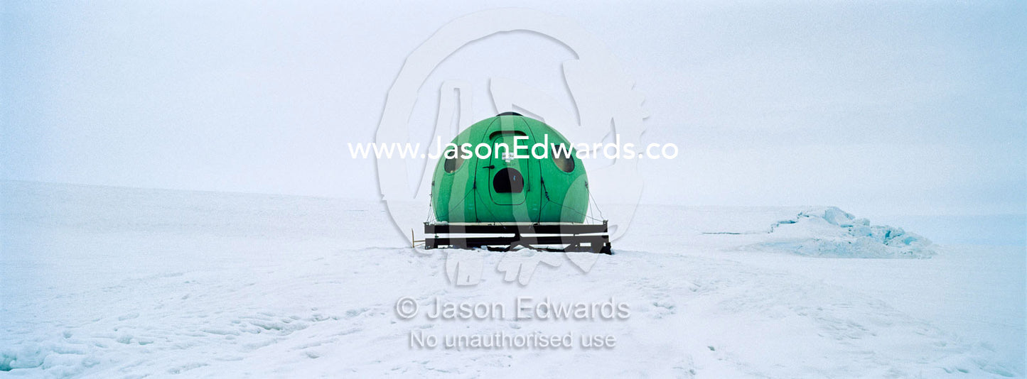A bright green Apple hut also called an igloo satellite cabin, are light-weight field shelters hemispherical in shape. Windless Bight, Ross Ice Shelf, Ross Island, Antarctica.