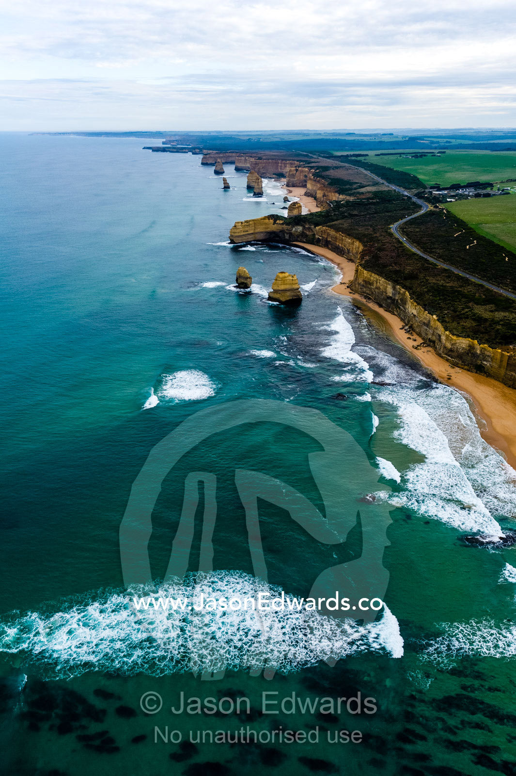 An aerial view of the sheer limestone cliffs and the Twelve Apostles pillars. Twelve Apostles, Port Campbell National, Great Ocean Road, Victoria, Australia.
