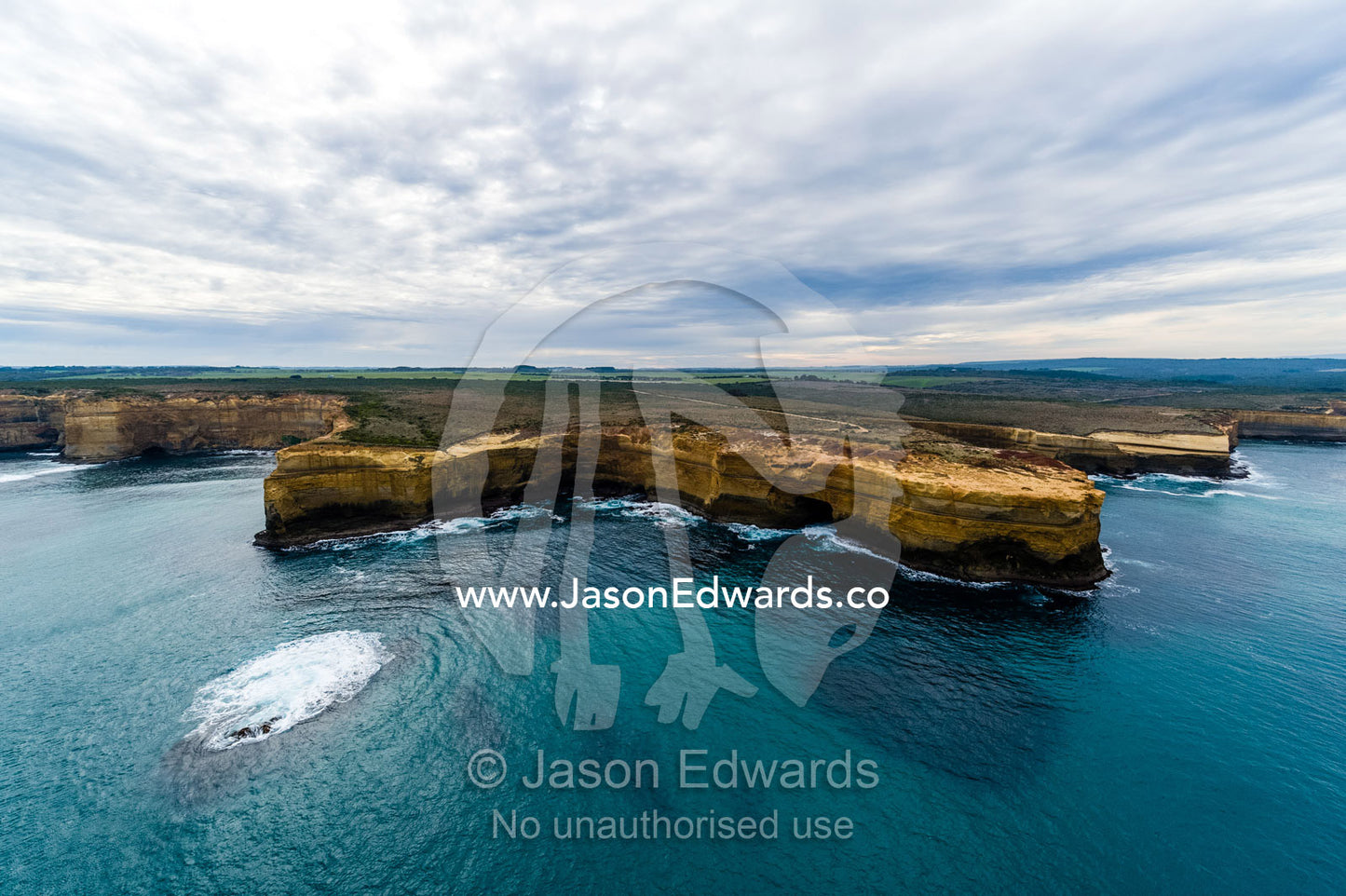 An aerial view of the ocean and the erosion on the sheer limestone cliffs and bays. Twelve Apostles, Port Campbell National, Great Ocean Road, Victoria, Australia.