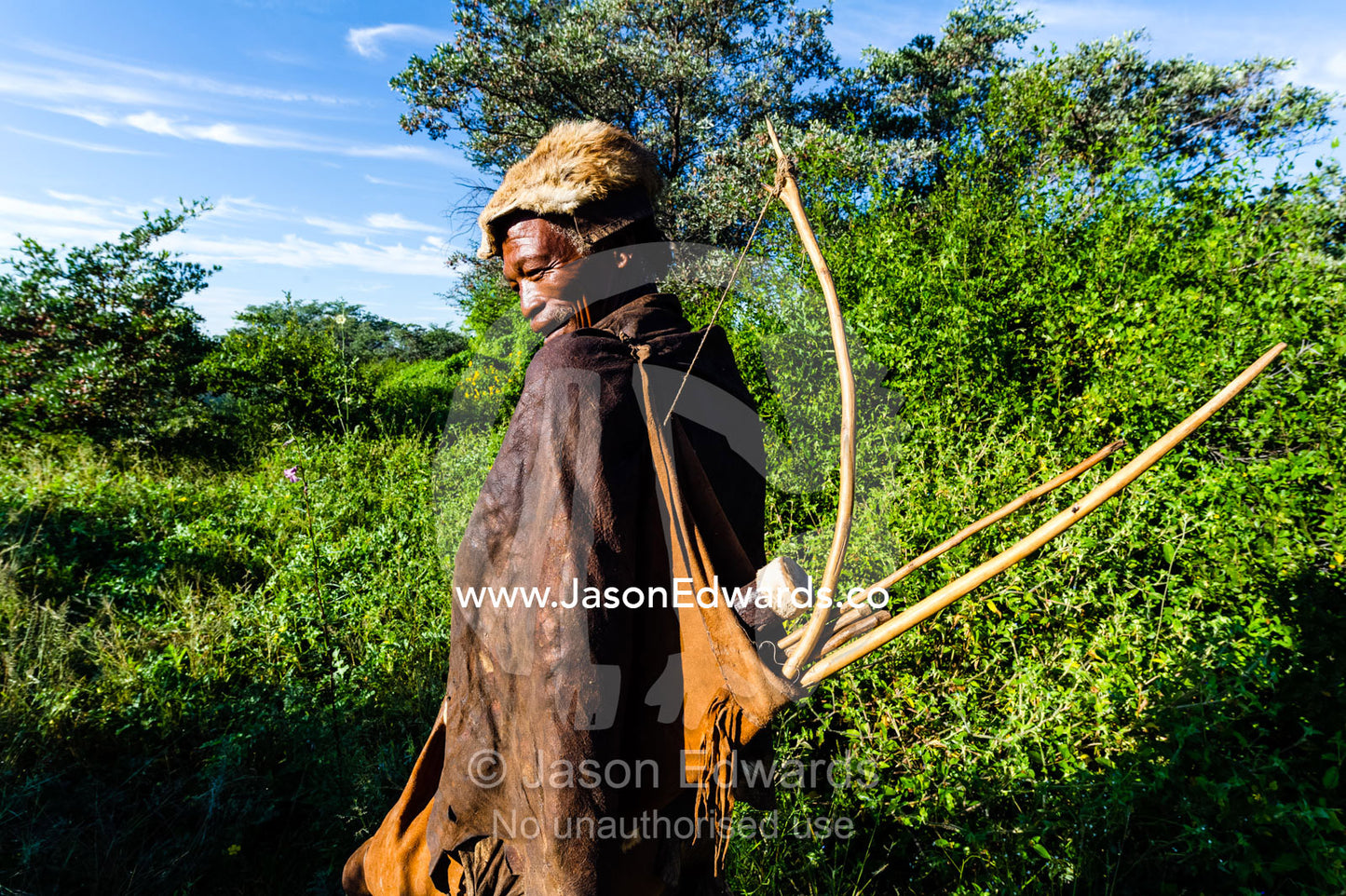 A San Bushmen carrying his bow and arrow quiver. Kalahari Desert, Botswana.