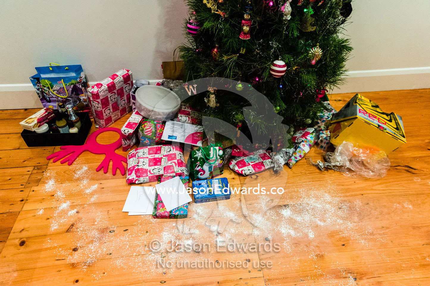 Talcum powder and opened presents around a Christmas tree on Christmas day. Carlton North, Melbourne, Victoria, Australia.