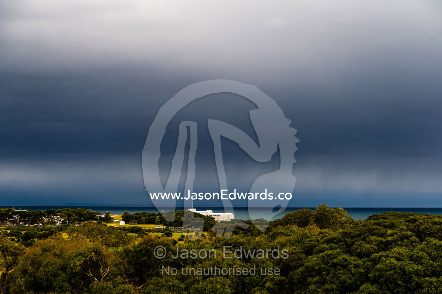 A storm rolls in from the ocean over a golf course. Torquay, Surf Coast, Victoria, Australia.