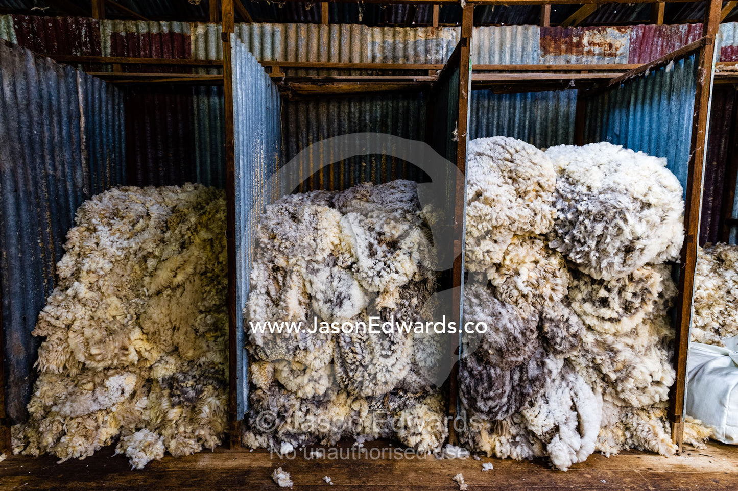 Sheep wool sorted into quality grades in a shearing shed. Euroa, Strathbogie, Victoria, Australia.