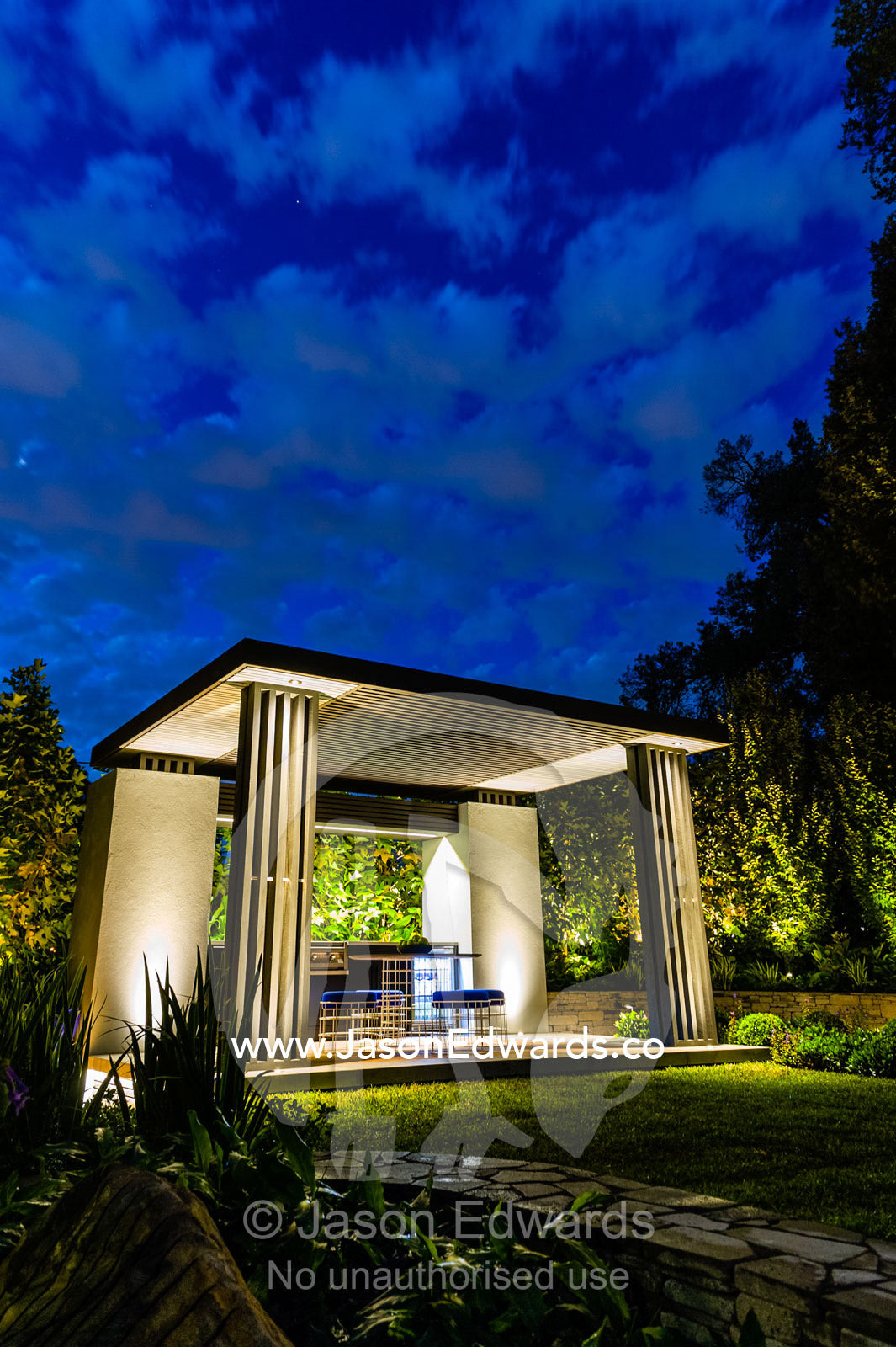 An architecturally designed outdoor patio and garden setting with spotlights at a garden show. Melbourne International Flower and Garden Show, Carlton Gardens, Carlton, Melbourne, Victoria, Australia.