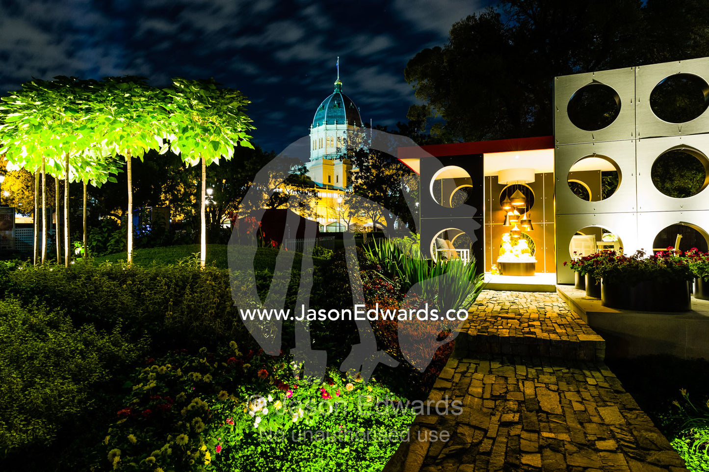 An architecturally designed outdoor patio and garden setting with spotlights at a garden show. Melbourne International Flower and Garden Show, Carlton Gardens, Carlton, Melbourne, Victoria, Australia.