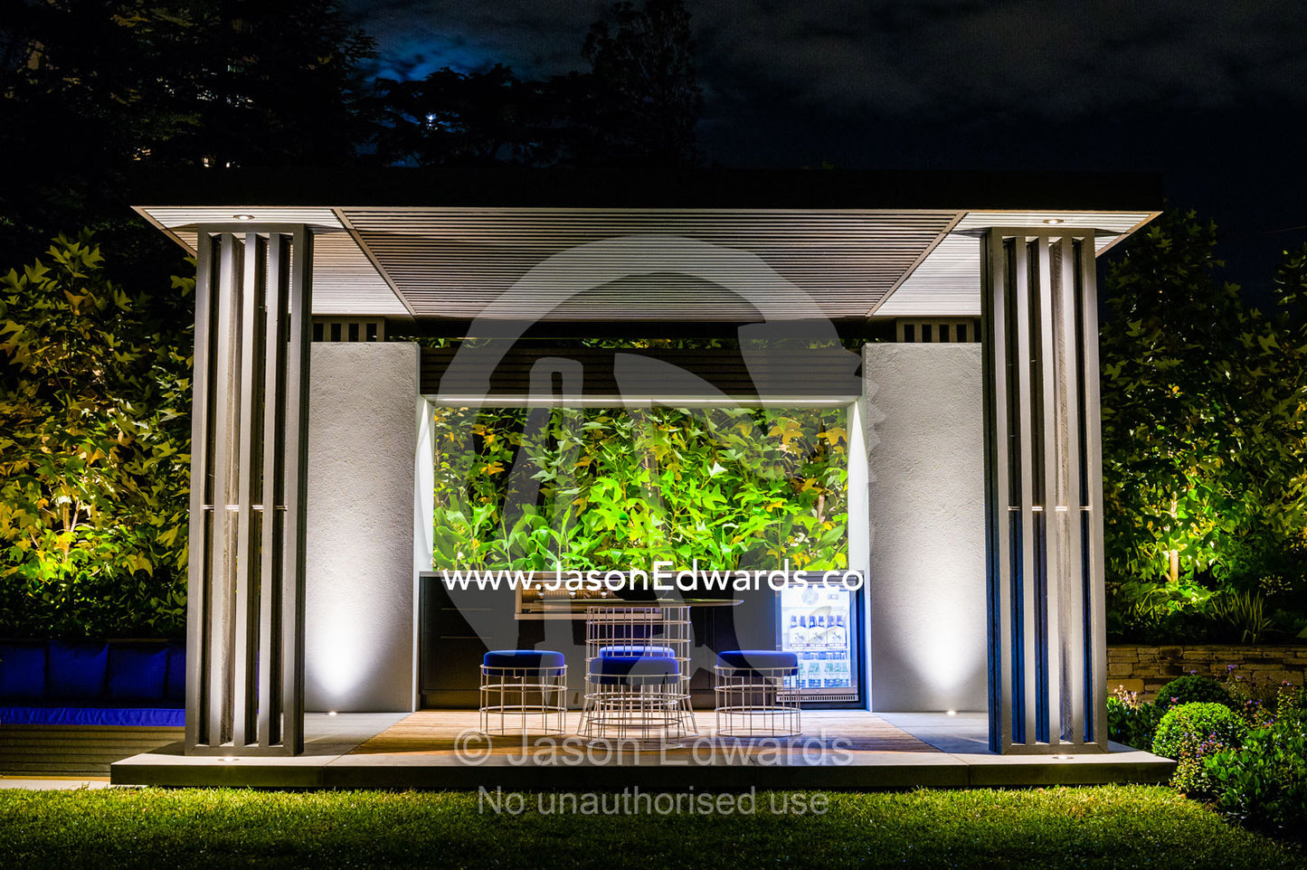 An architecturally designed outdoor patio and garden setting with spotlights at a garden show. Melbourne International Flower and Garden Show, Carlton Gardens, Carlton, Melbourne, Victoria, Australia.