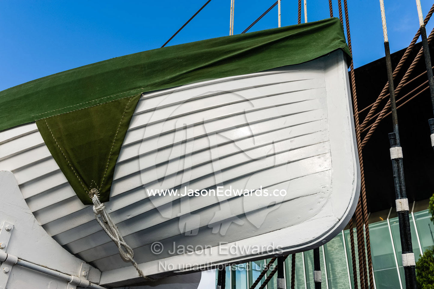 A timber lifeboat on the deck of an antique sailing ship museum. Polly Woodside, South Wharf Precinct, Yarra River, Melbourne, Victoria, Australia.